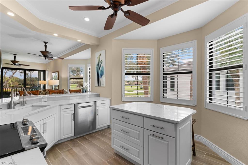 2421 Ravenna Boulevard, Unit 202 Naples, FL 34109 - Photo 3 of 42 a kitchen with a sink stove and cabinets