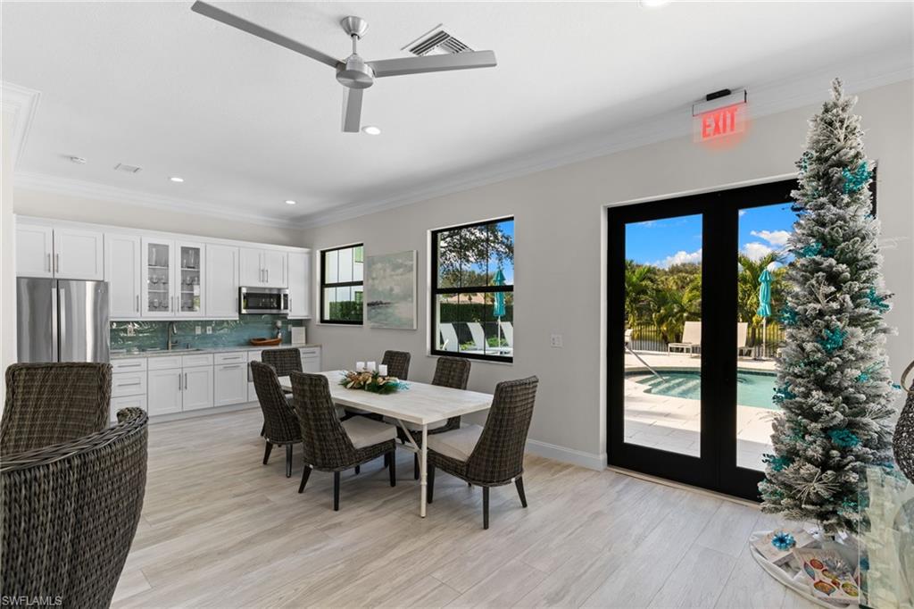2421 Ravenna Boulevard, Unit 202 Naples, FL 34109 - Photo 37 of 42 a view of a dining room with furniture and window