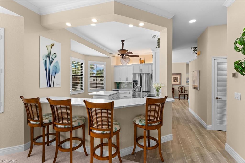 2421 Ravenna Boulevard, Unit 202 Naples, FL 34109 - Photo 6 of 42 a dining room with furniture and window