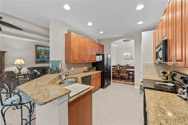 a kitchen with stainless steel appliances granite countertop a stove sink and cabinets