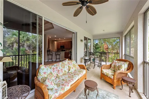 a living room with furniture and floor to ceiling windows