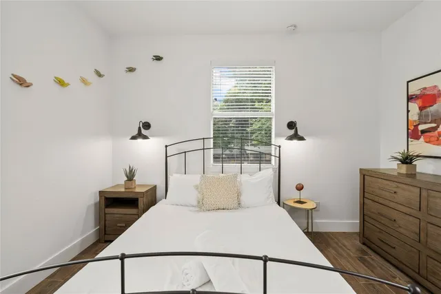 a living room with furniture a flat screen tv and a window