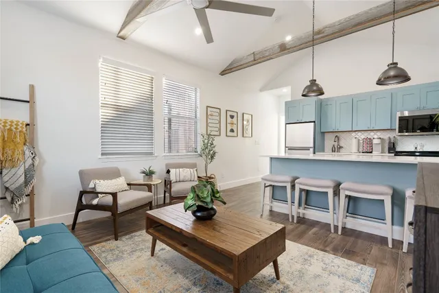 a living room with furniture a window and kitchen view