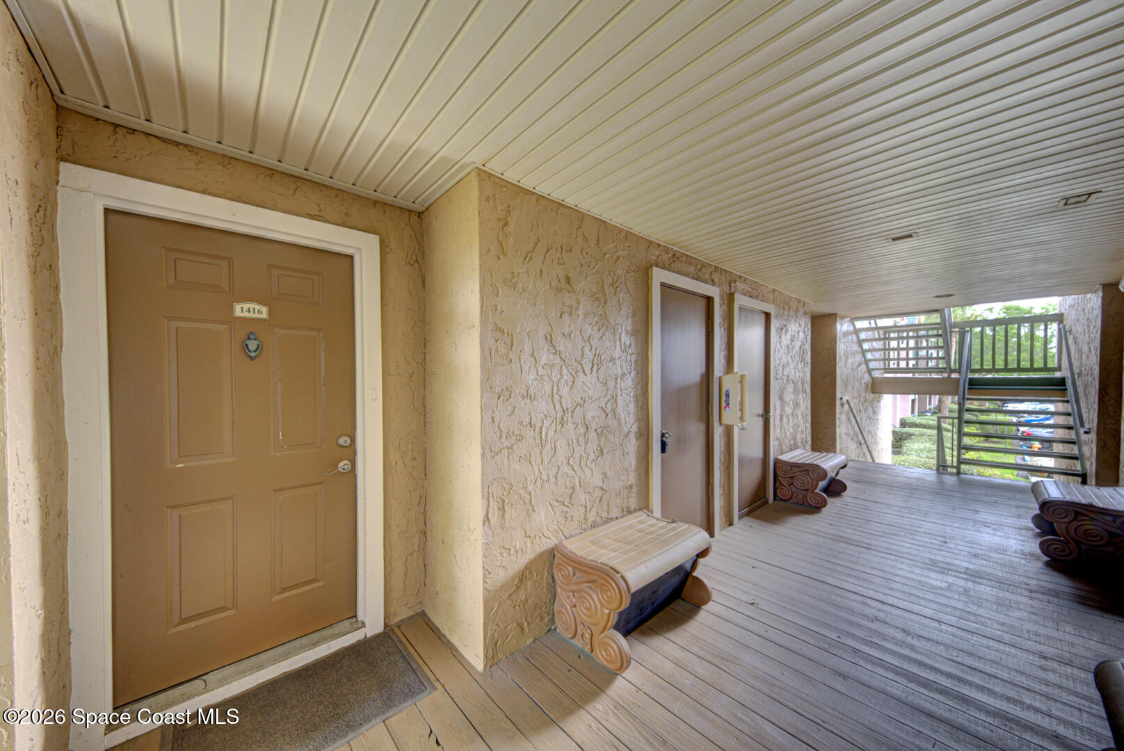 7667 North Wickham Road, Unit 1416 Melbourne, FL 32940 - Photo 3 of 41 a spacious bedroom with a balcony a bed and a couch