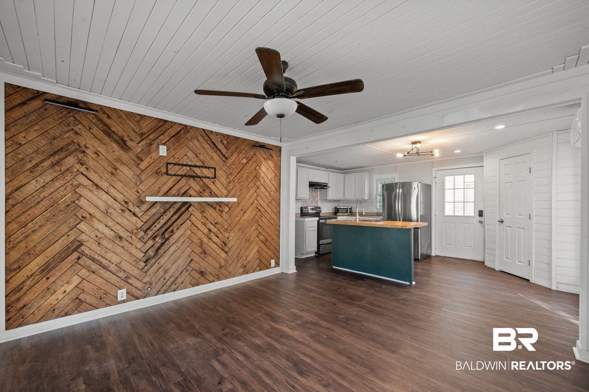 503 North Holly Street Foley, AL 36535 - Photo 3 of 23 Kitchen featuring dark wood-type flooring, wood counters, sink, appliances with stainless steel finishes, and wood walls