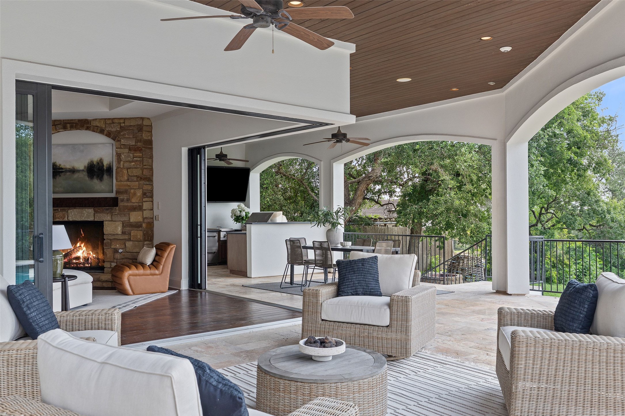 1414 The High Road Austin, TX 78746 - Photo 30 of 40 An inviting outdoor living space with a cozy fireplace and expansive patio beckons for relaxation.