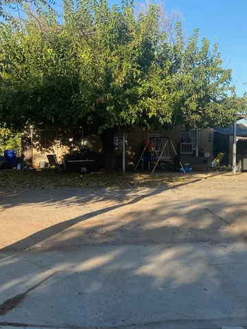 a view of a patio with table and chairs under an umbrella
