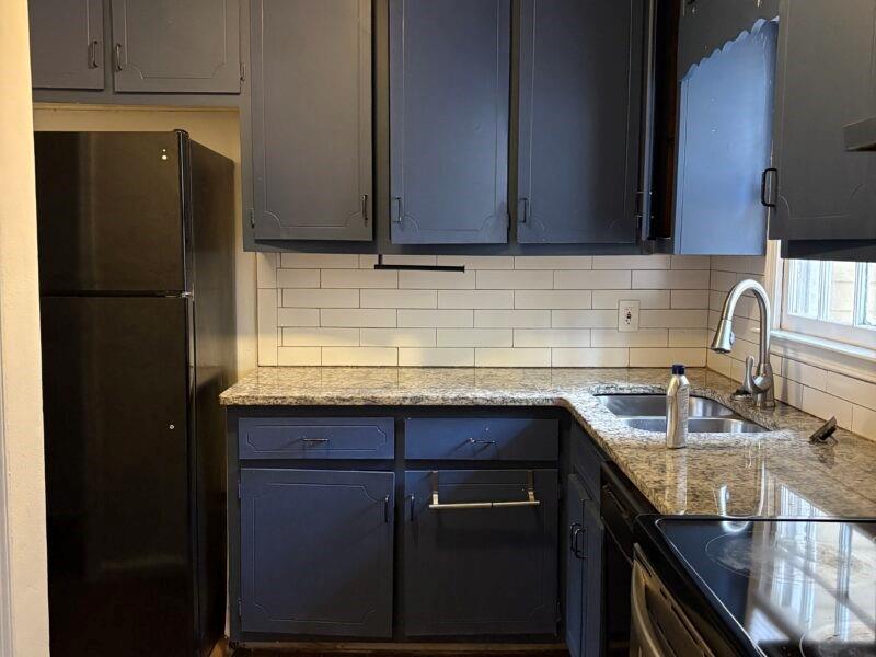 5510 Estates Court Norcross, GA 30093 - Photo 12 of 14 a kitchen with granite countertop a sink stove and refrigerator