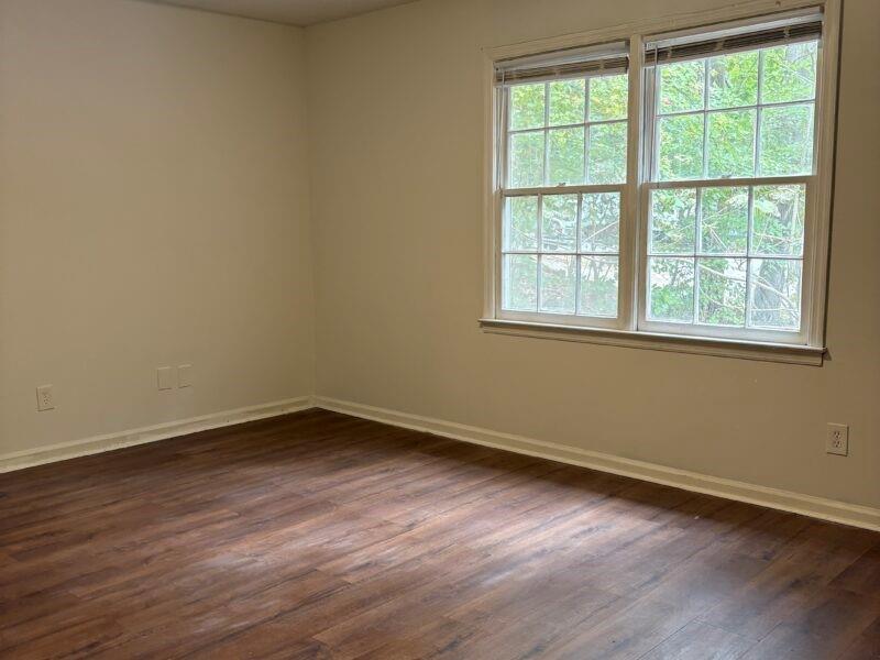5510 Estates Court Norcross, GA 30093 - Photo 7 of 14 a view of an empty room with wooden floor and a window