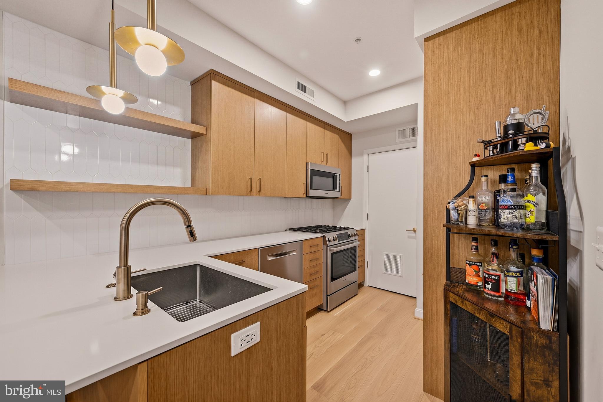 1402 12th Street Northwest, Unit 3 Washington, DC 20005 - Photo 12 of 23 a kitchen with stainless steel appliances granite countertop a stove a sink and a refrigerator