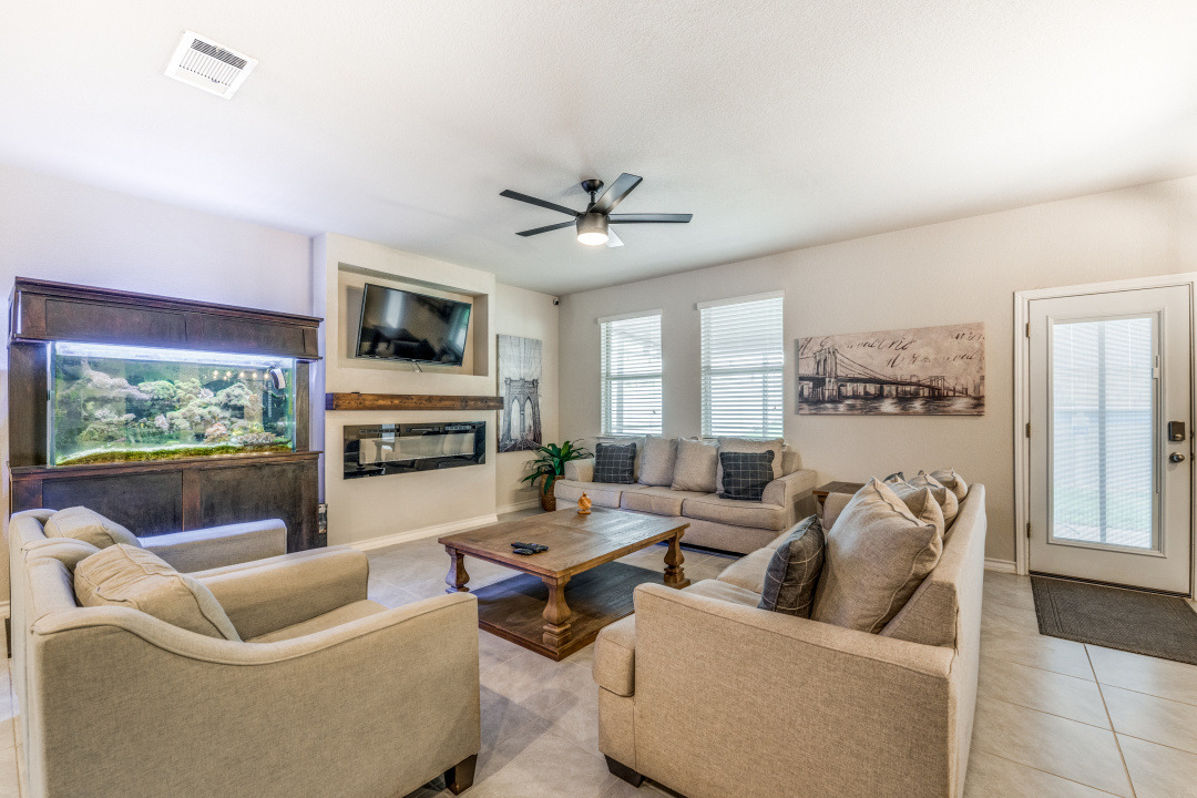 5921 Lehman Way Austin, TX 78747 - Photo 5 of 25 A comfortable living area showcasing a contemporary fireplace and an attractive tile floor.