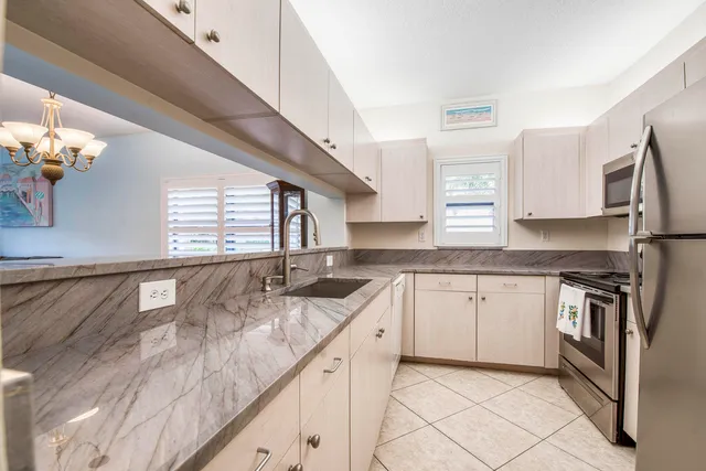 a close view of a sink and a refrigerator in a kitchen