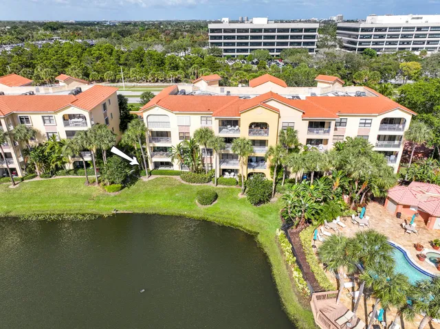 a aerial view of a house with a garden and lake view