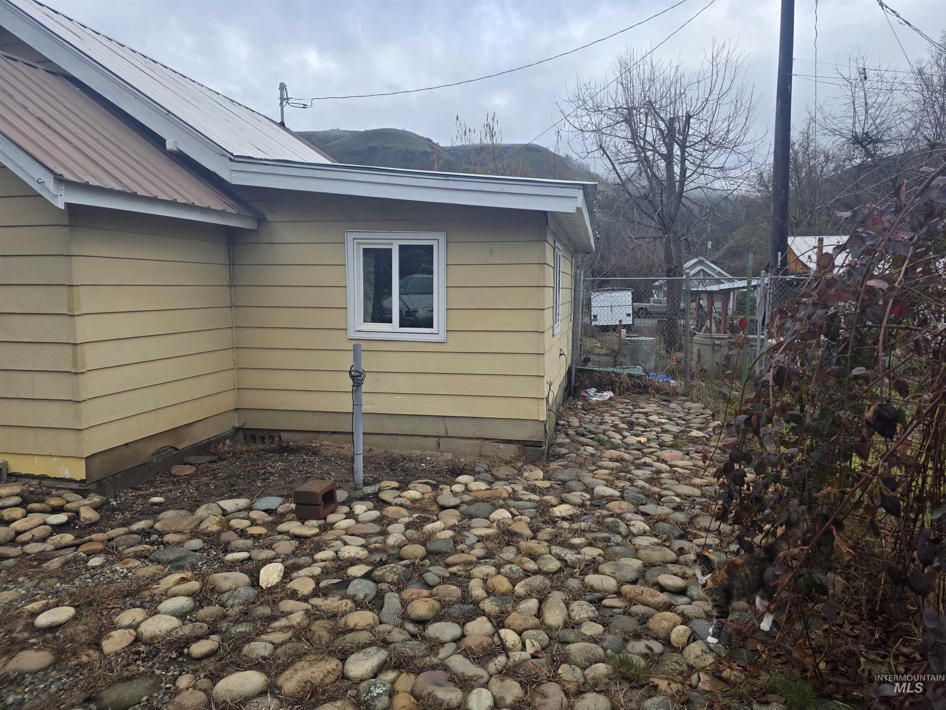 210 Pine Avenue Kooskia, ID 83539 - Photo 2 of 8 View of side of home with a metal roof