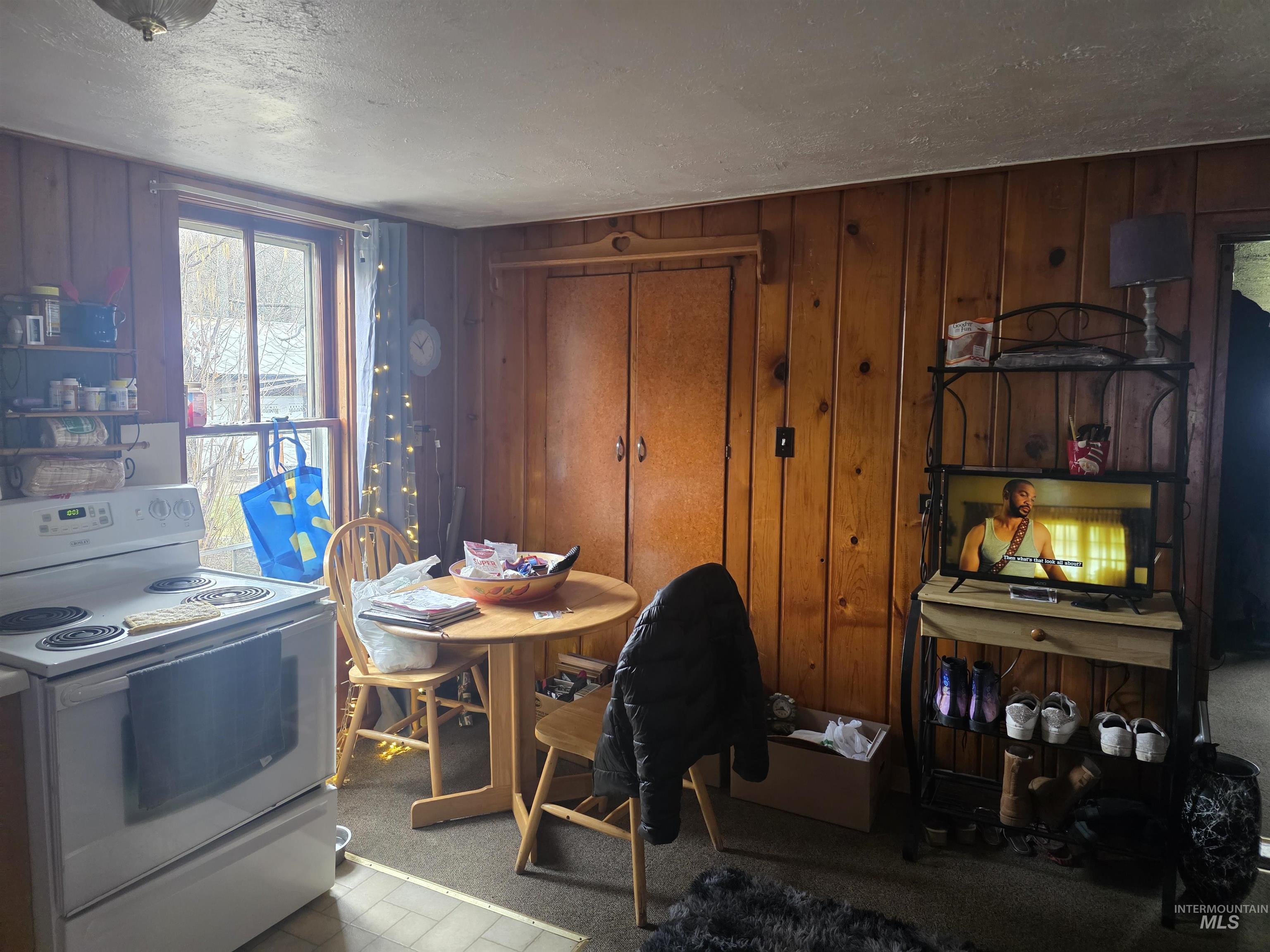 210 Pine Avenue Kooskia, ID 83539 - Photo 5 of 8 Dining area with wooden walls and a textured ceiling