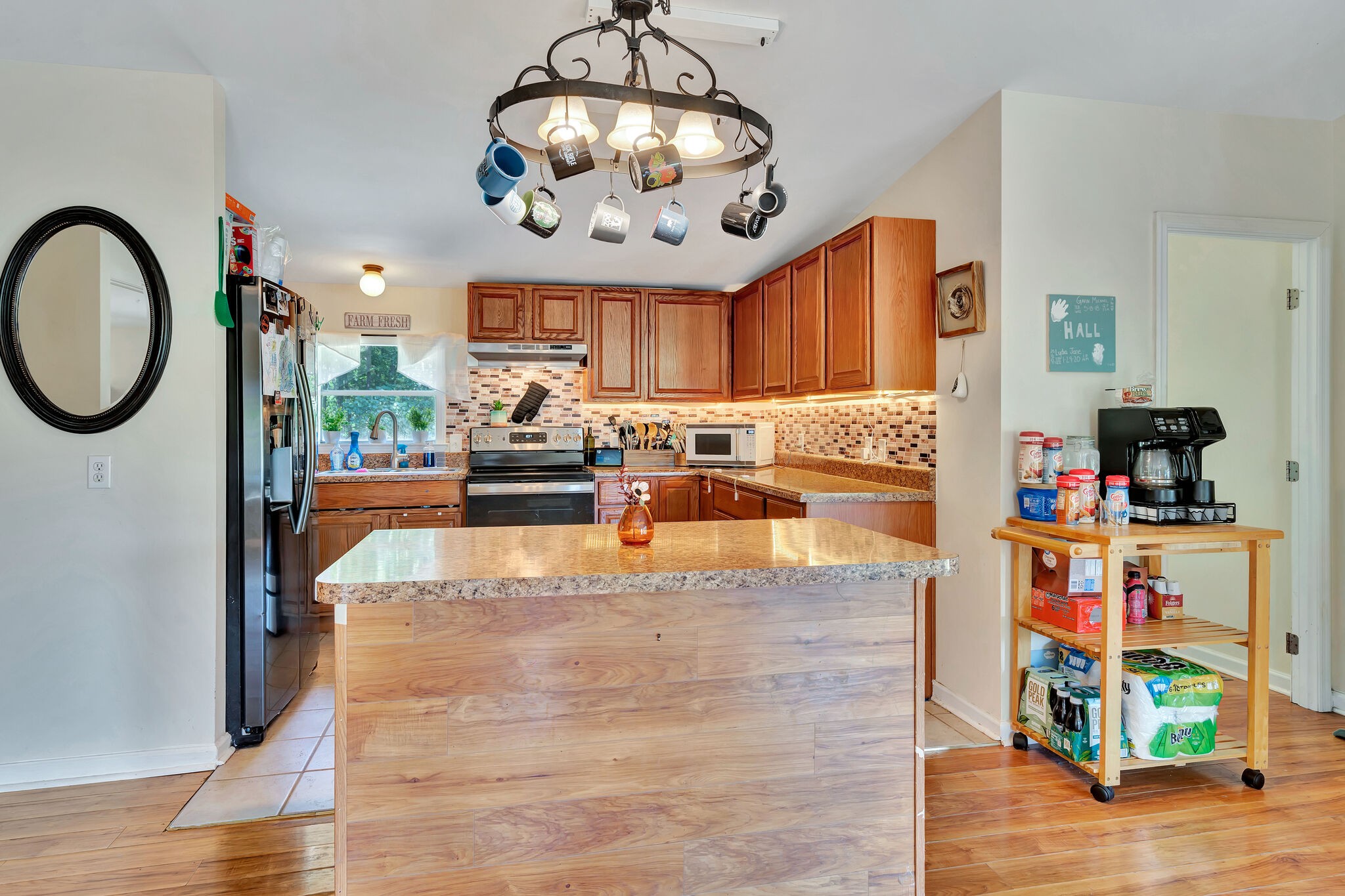 175 B Mitchell Road Portland, TN 37148 - Photo 8 of 29 a large kitchen with stainless steel appliances granite countertop a stove and a wooden floor