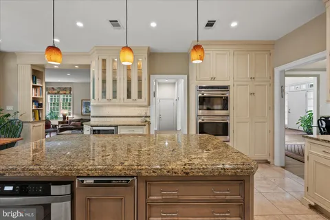 a kitchen with stainless steel appliances granite countertop a stove a refrigerator and a wooden cabinets