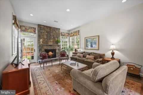 a living room with furniture window and a fireplace