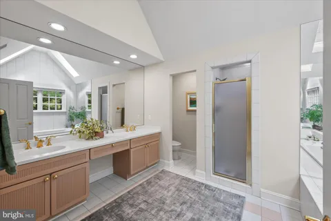 a spacious bathroom with a double vanity sink and a mirror