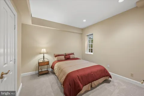 a bedroom with a bed and a night stand