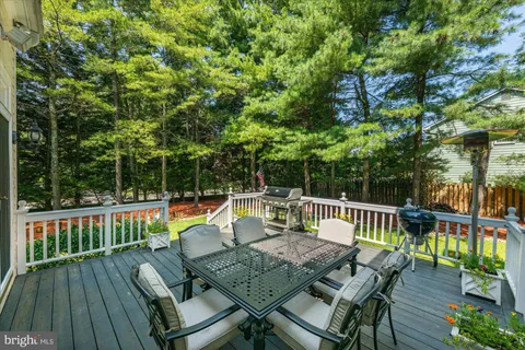a view of backyard with a table and chairs with wooden floor