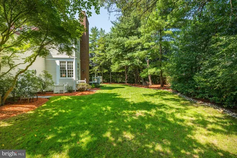 a view of house with backyard