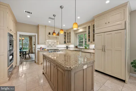 a kitchen with stainless steel appliances granite countertop a stove and a refrigerator