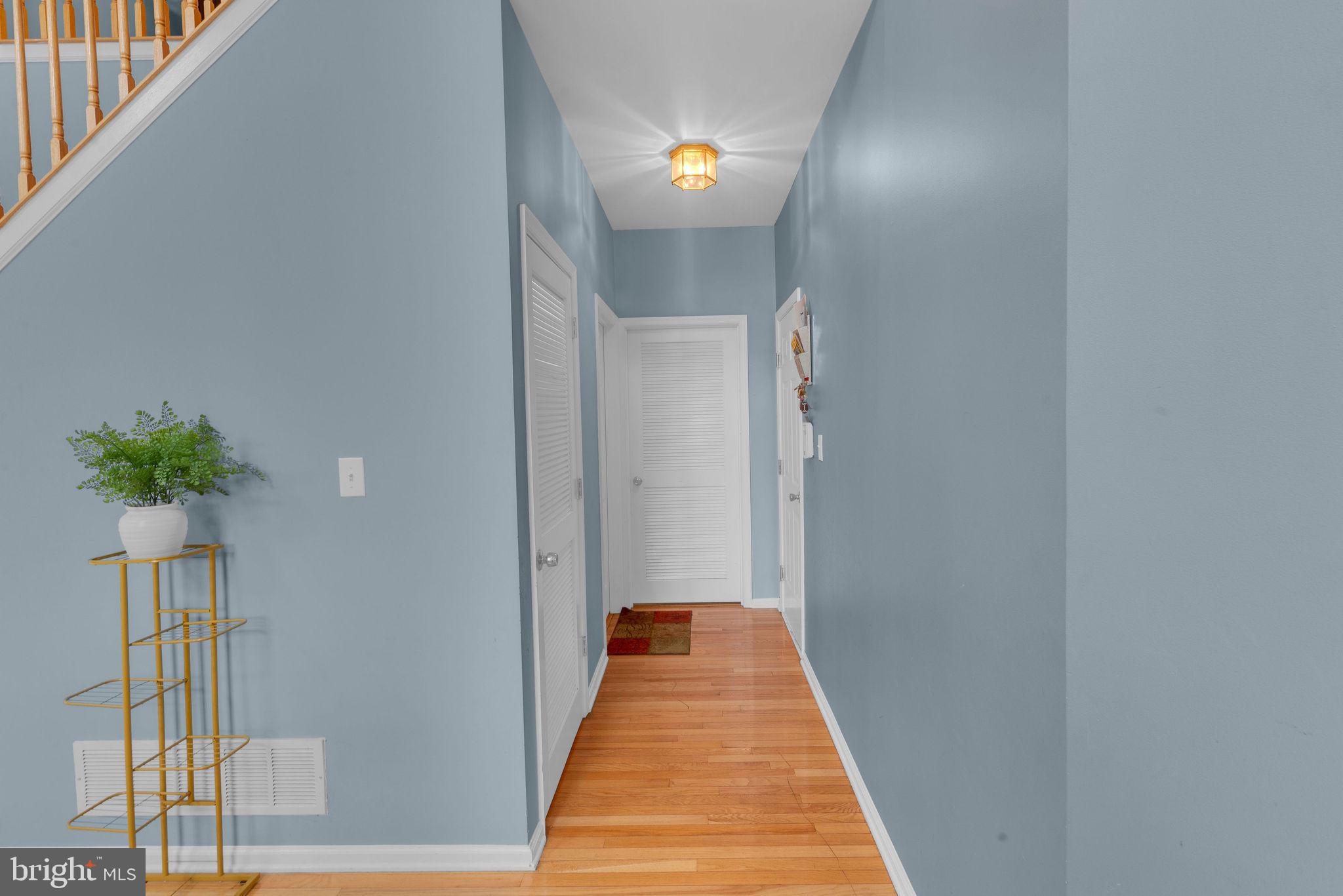 16 Cardiff Court Princeton Junction, NJ 08550 - Photo 21 of 60 a view of a hallway with wooden floor and a potted plant