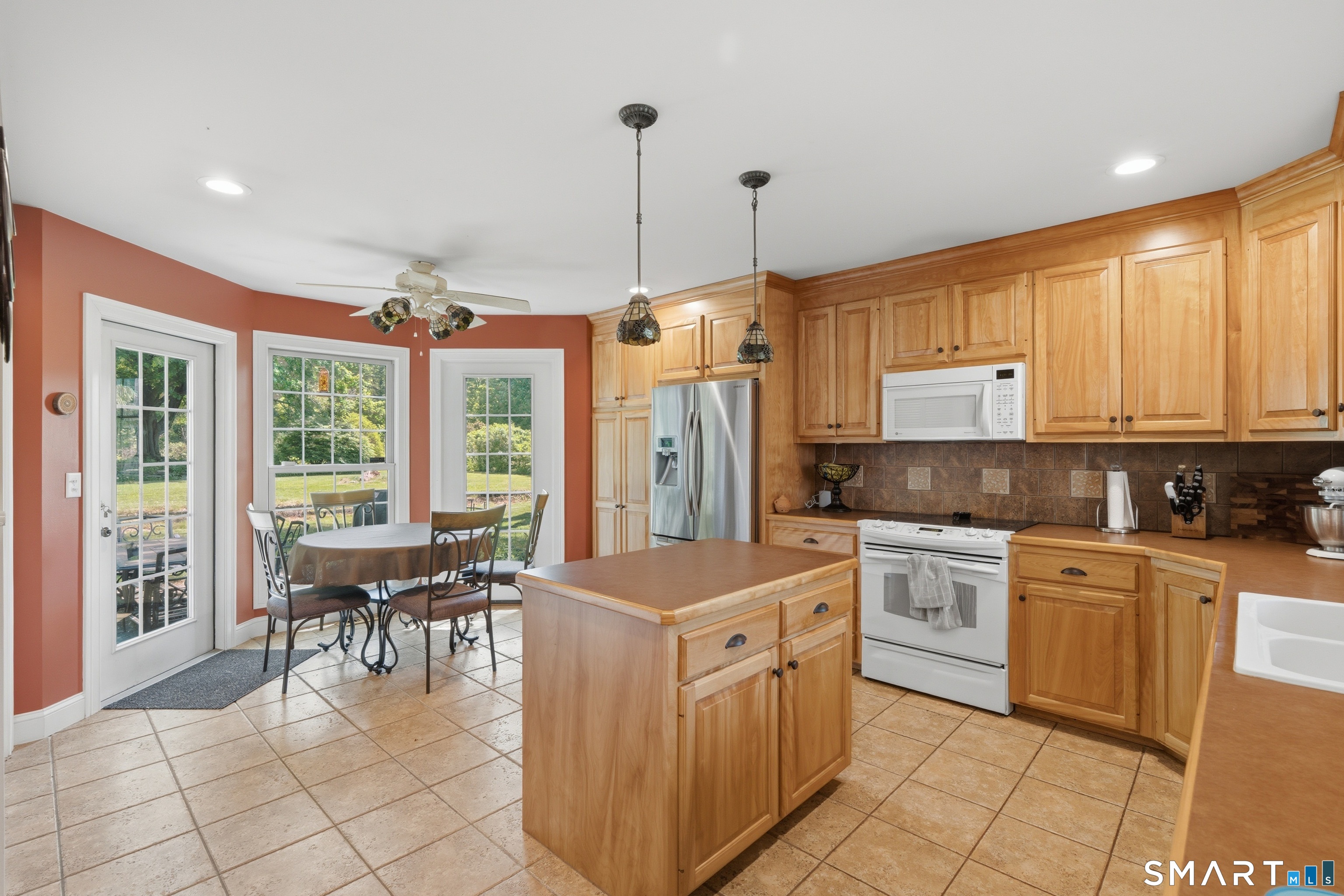 48 Case Road Burlington, CT 06013 - Photo 4 of 39 a kitchen with stainless steel appliances granite countertop a stove top oven a sink a dining table and chairs