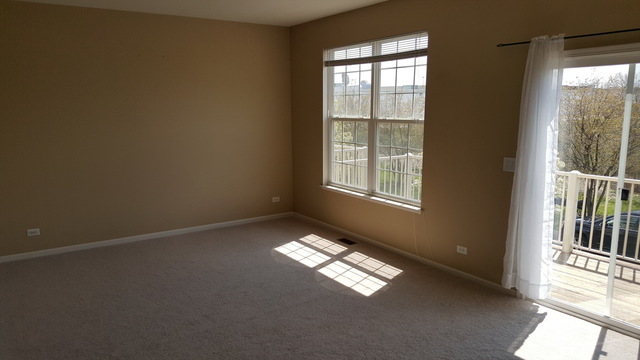4205 Drexel Avenue Aurora, IL 60504 - Photo 4 of 16 an empty room with windows