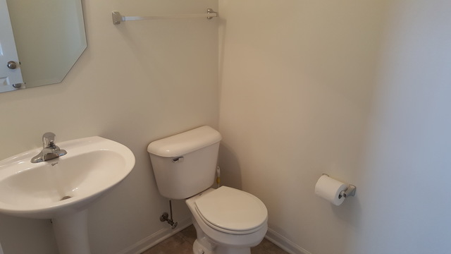 4205 Drexel Avenue Aurora, IL 60504 - Photo 7 of 16 a white toilet sitting next to a white sink