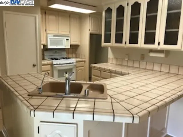 a kitchen with a sink and cabinets