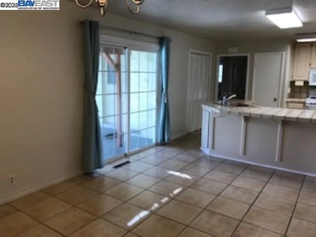 a view of a kitchen with a sink and a window