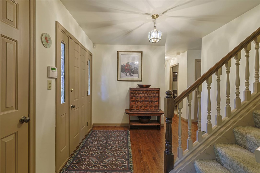 1757 Phillips Road Lebanon, OH 45036 - Photo 7 of 51 The inviting entryway features hardwood floors, a classic staircase, and a decorative light fixture, creating a warm welcome.