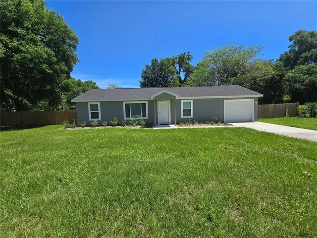 a front view of house with yard and green space