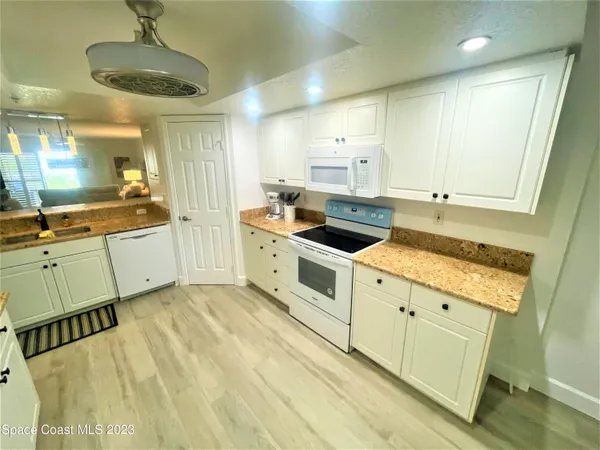 a kitchen with stainless steel appliances a stove a sink and a refrigerator