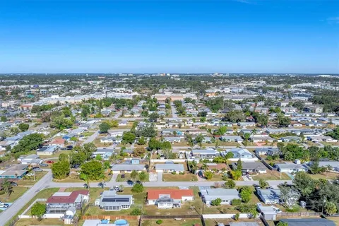 an aerial view of residential houses with city view
