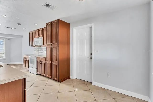 a view of kitchen with furniture and cabinets