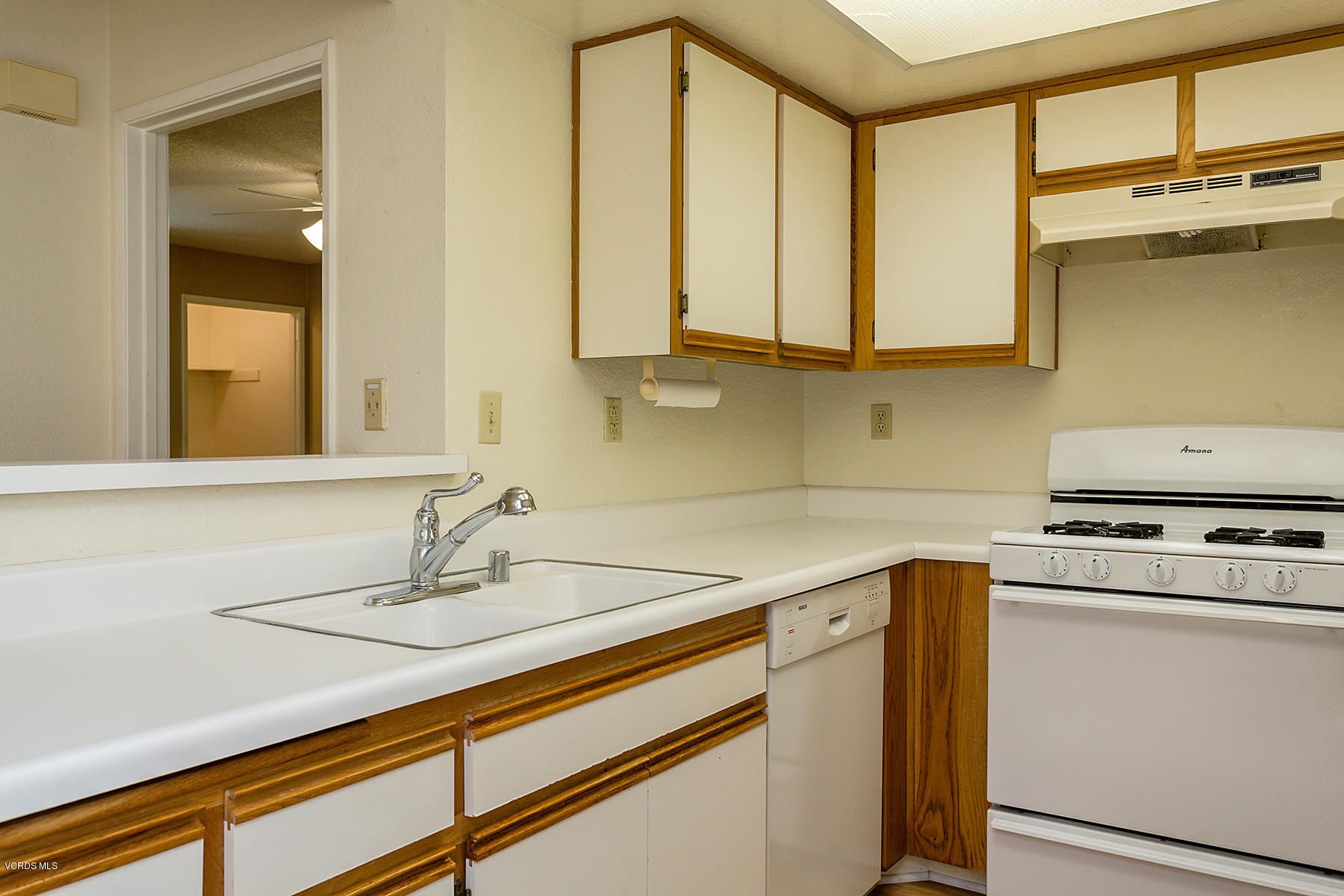 1195 Fitzgerald Road, Unit F Simi Valley, CA 93065 - Photo 8 of 18 a kitchen with stainless steel appliances a sink stove and cabinets