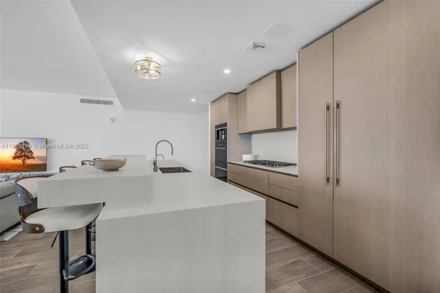 a bathroom with a granite countertop toilet a sink and a mirror