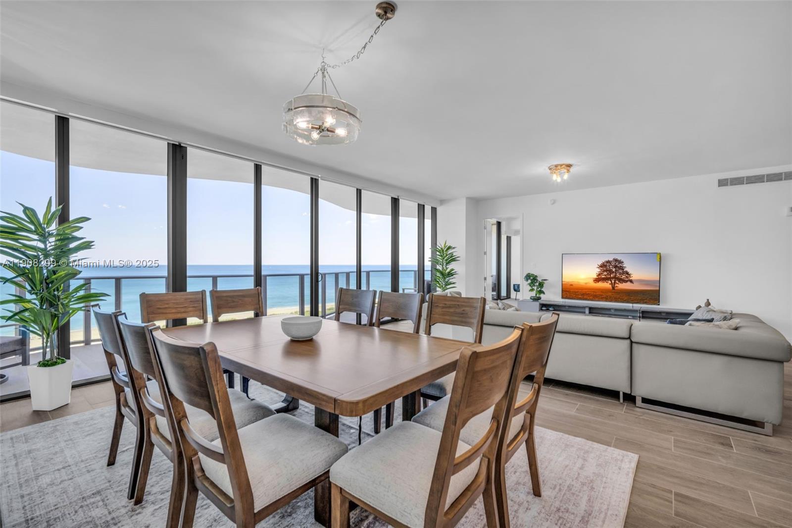 900 North Ocean Boulevard, Unit 503 Pompano Beach, FL 33062 - Photo 13 of 99 a dining room with furniture a chandelier and wooden floor