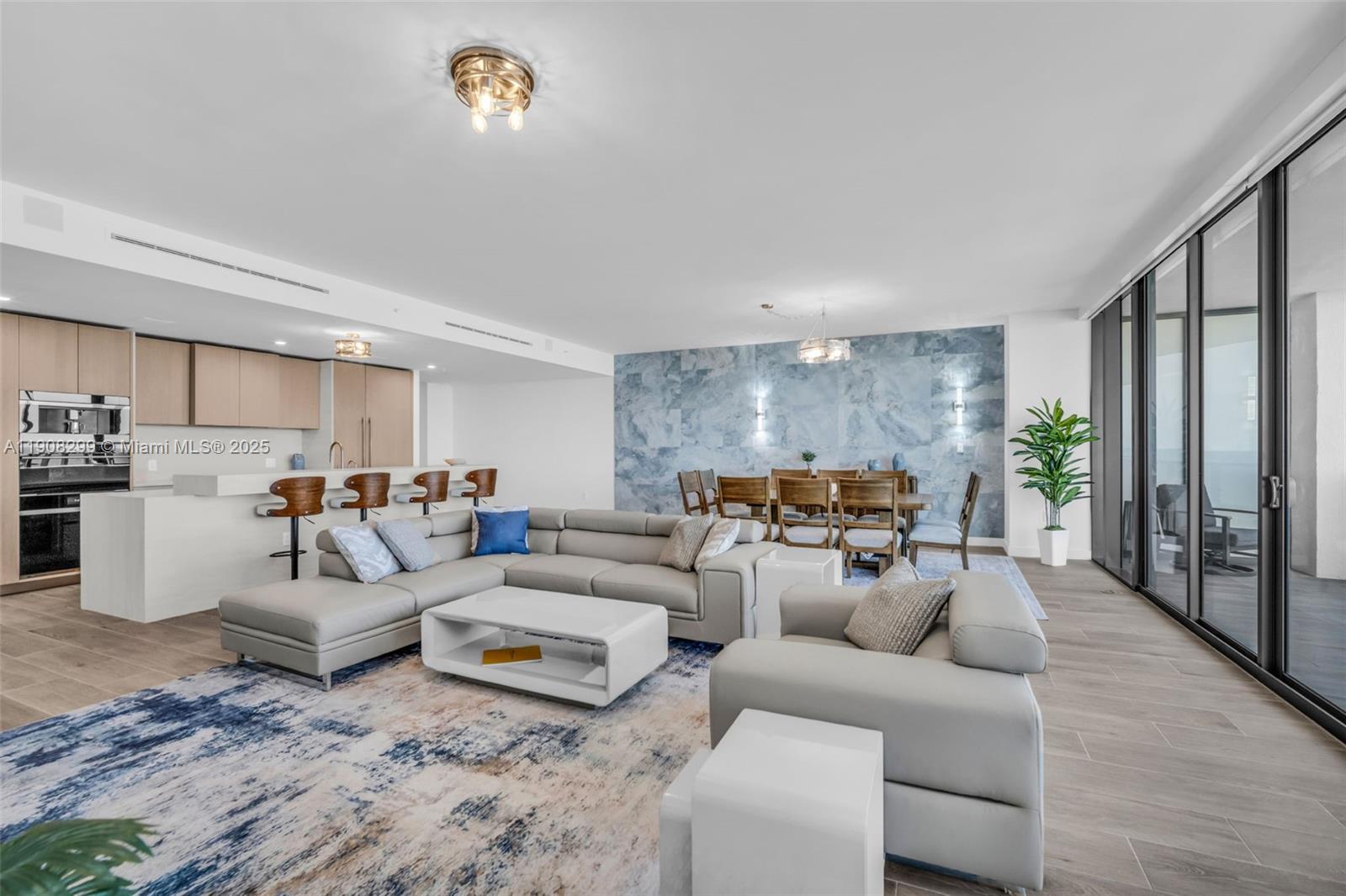 900 North Ocean Boulevard, Unit 503 Pompano Beach, FL 33062 - Photo 16 of 99 a living room with furniture and a chandelier