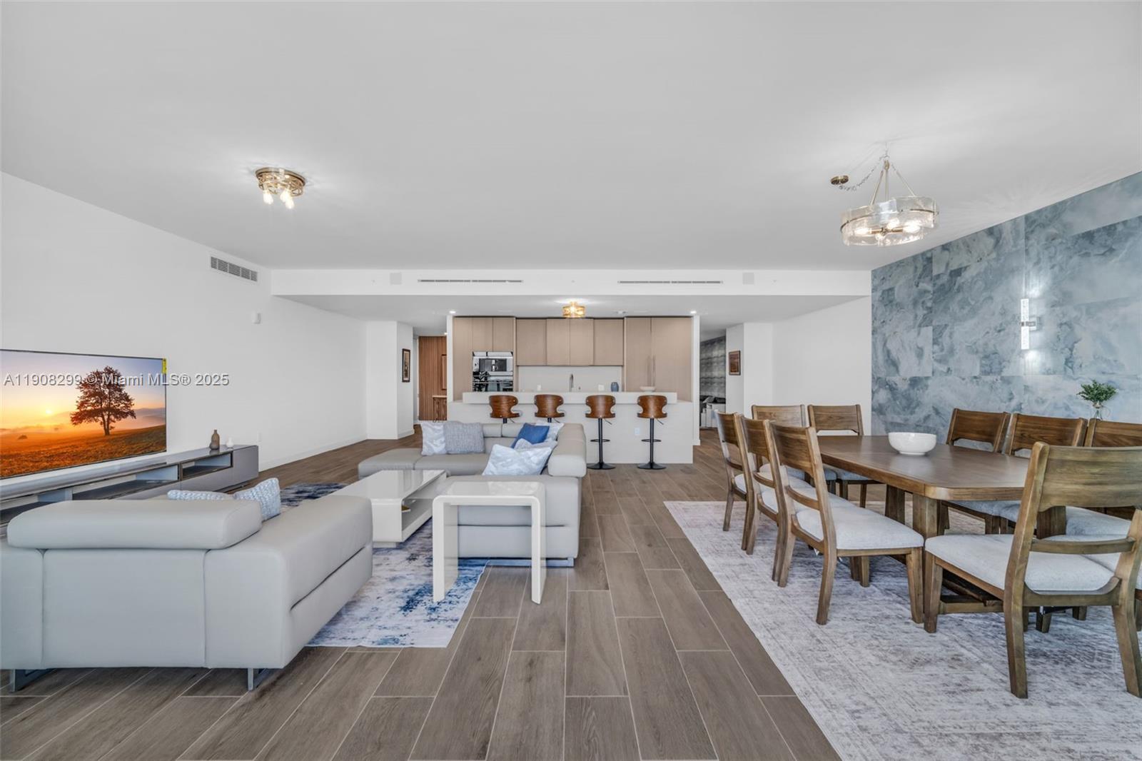 900 North Ocean Boulevard, Unit 503 Pompano Beach, FL 33062 - Photo 17 of 99 a living room with furniture and a flat screen tv