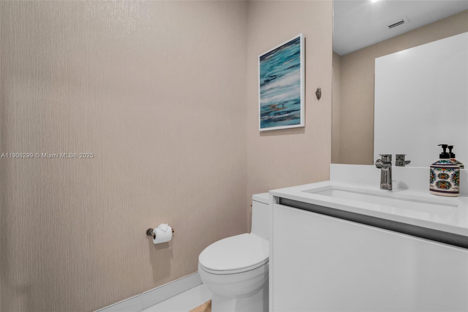 900 North Ocean Boulevard, Unit 503 Pompano Beach, FL 33062 - Photo 18 of 99 a bathroom with a granite countertop toilet a sink and a mirror