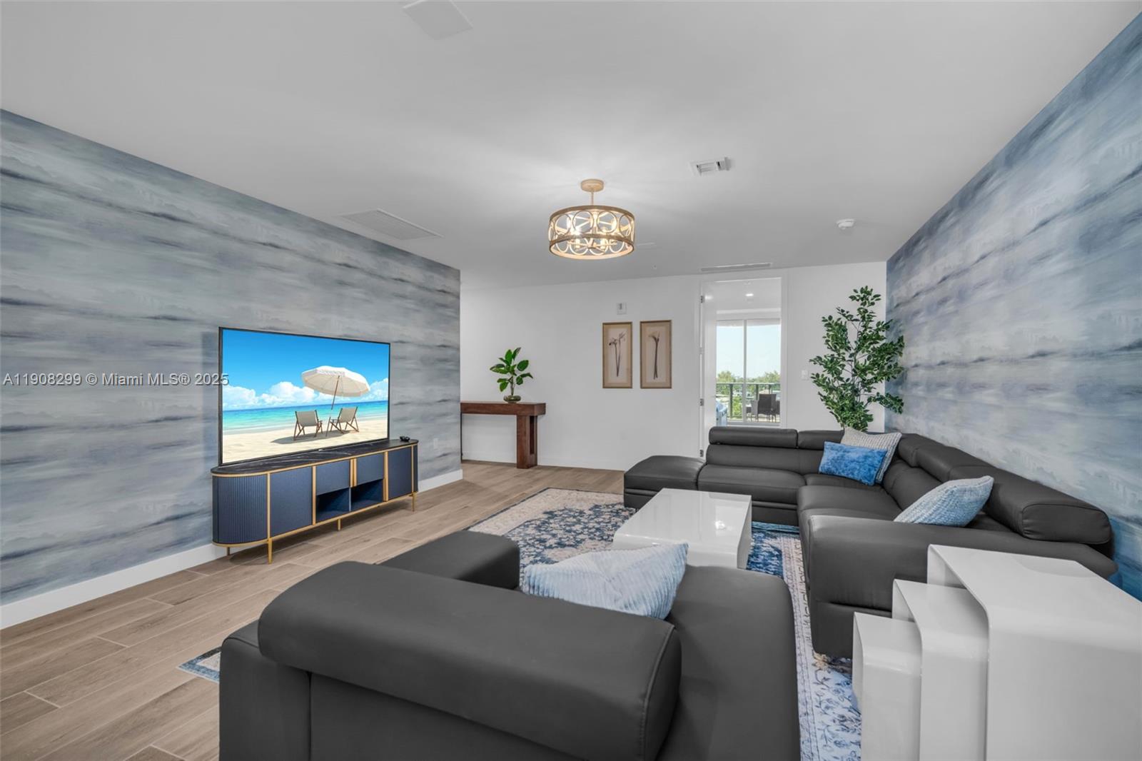 900 North Ocean Boulevard, Unit 503 Pompano Beach, FL 33062 - Photo 19 of 99 a living room with furniture and a flat screen tv