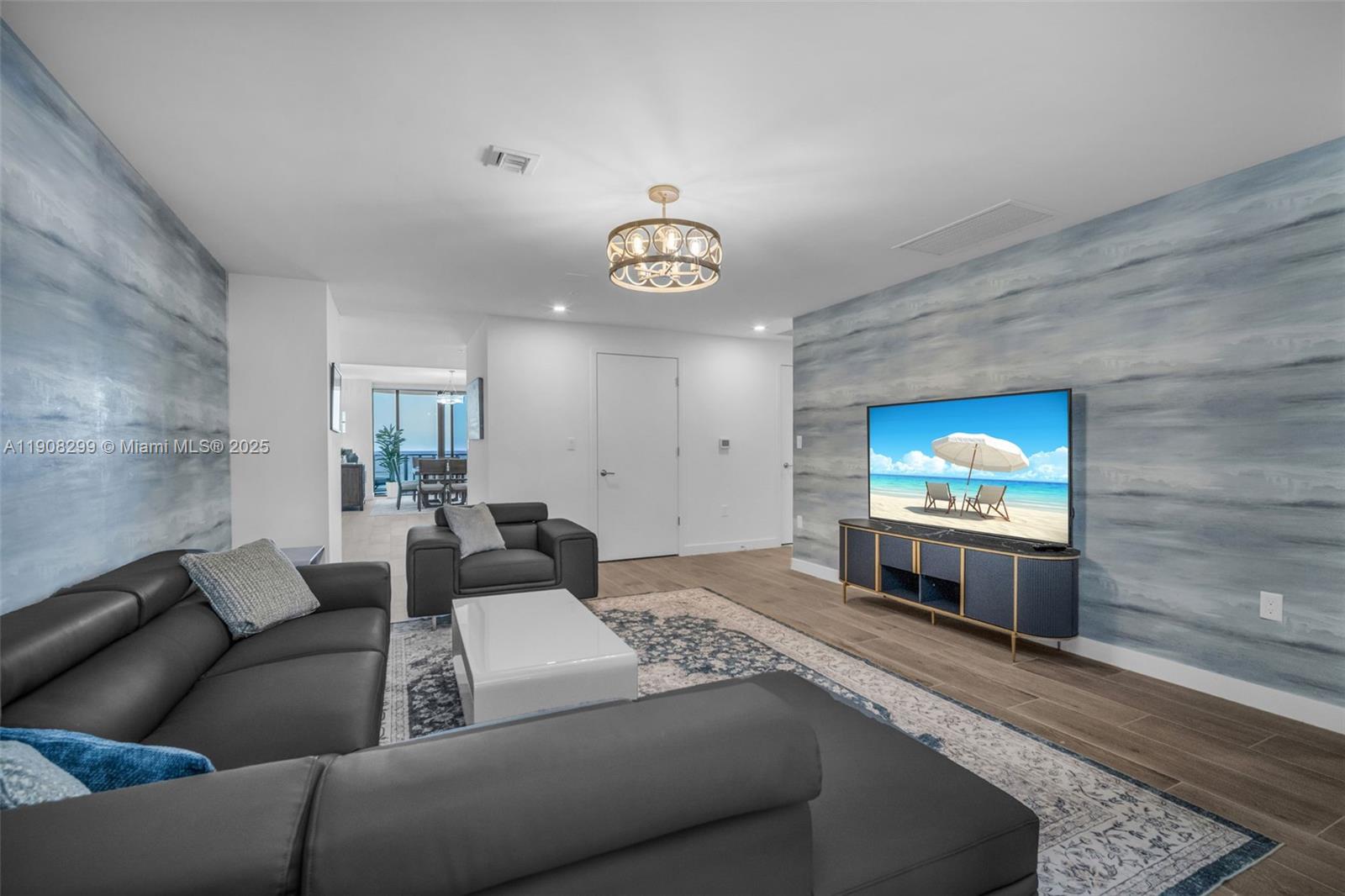 900 North Ocean Boulevard, Unit 503 Pompano Beach, FL 33062 - Photo 21 of 99 a living room with furniture and a flat screen tv