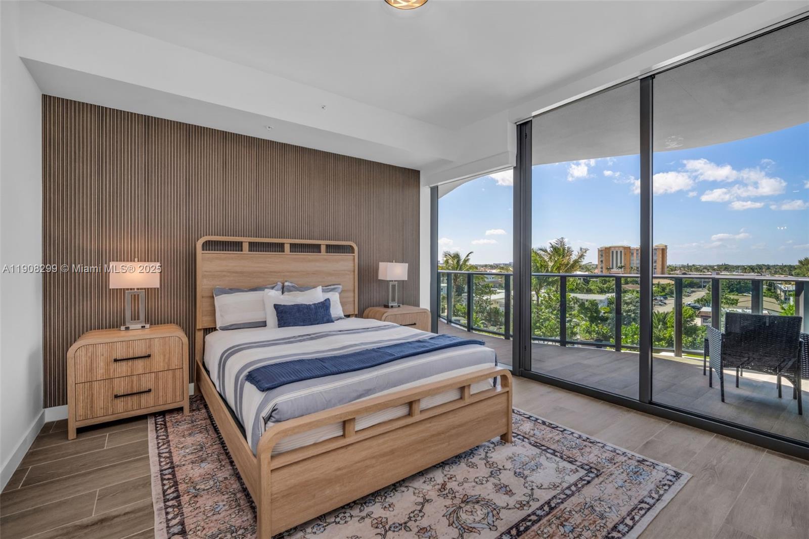 900 North Ocean Boulevard, Unit 503 Pompano Beach, FL 33062 - Photo 24 of 99 a bedroom with a large bed and a view of living room