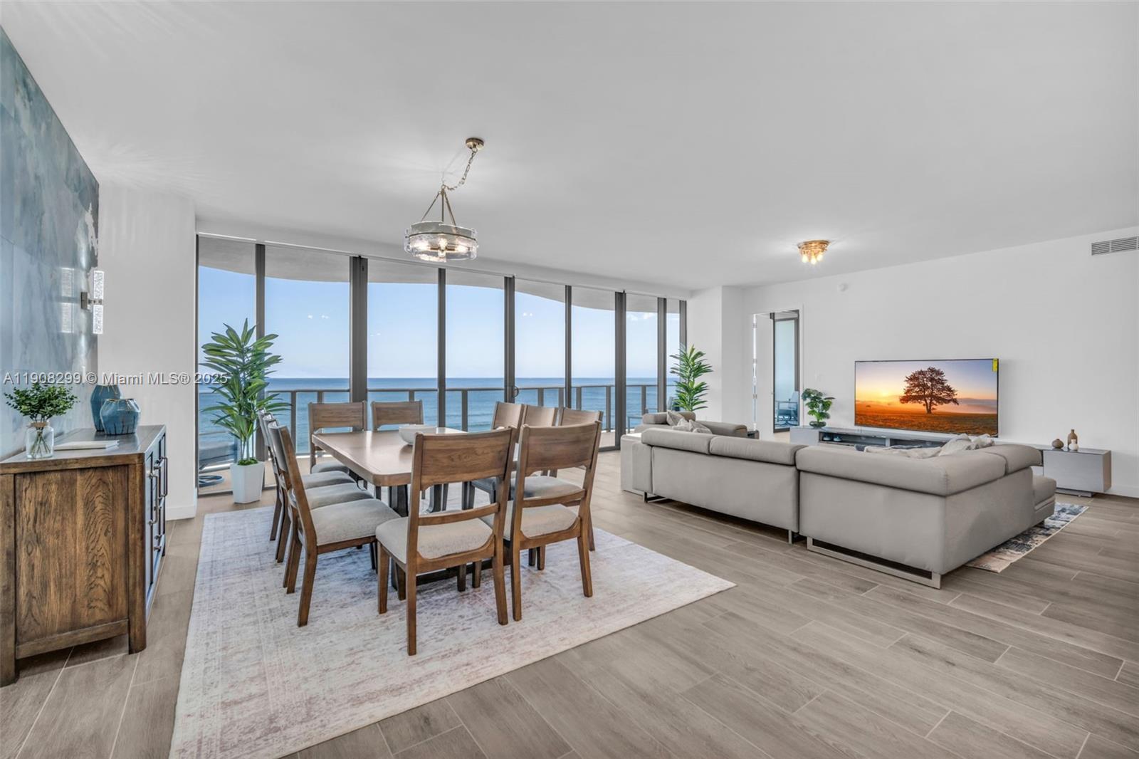 900 North Ocean Boulevard, Unit 503 Pompano Beach, FL 33062 - Photo 3 of 99 a dining room with furniture a chandelier and wooden floor