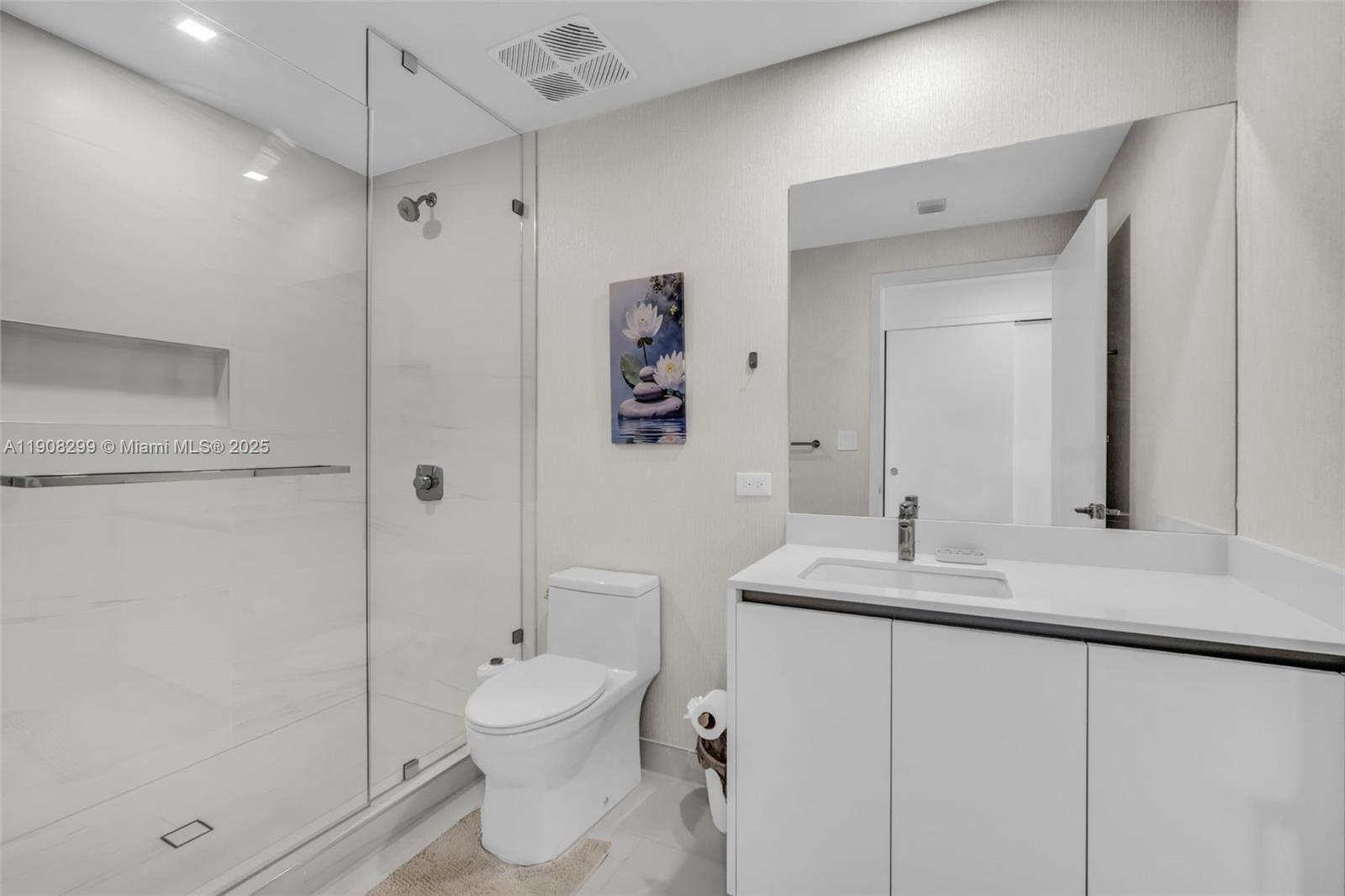 900 North Ocean Boulevard, Unit 503 Pompano Beach, FL 33062 - Photo 31 of 99 a bathroom with a toilet sink and shower