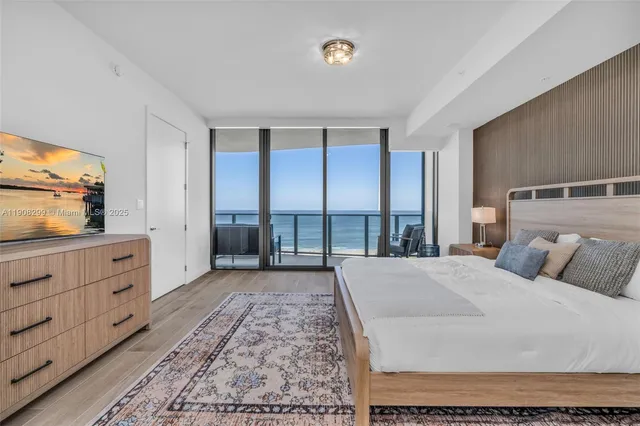 a view of a balcony with a floor to ceiling window and a potted plant